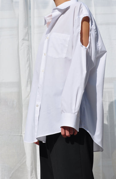 WHITE BUTTON DOWN WITH SLEEVE CUT OUT.