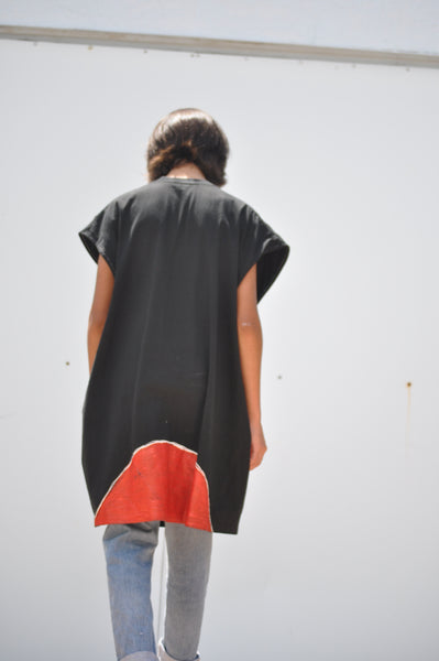 BACK IMAGE OF PAINTED OVERSIZED MUSCLE TEE ON A MODEL.