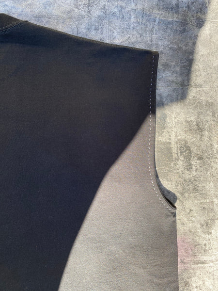 DETAILED IMAGE OF CONTRAST HAND STITCHING AT ARMHOLE.