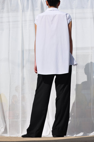 BACK IMAGE OF WHITE BUTTON DOWN WITH SLEEVE CUT OUT.