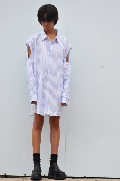 FRONT IMAGE OF OVERSIZED BUTTON DOWN SHIRT WITH SLEEVES CUT OUT.