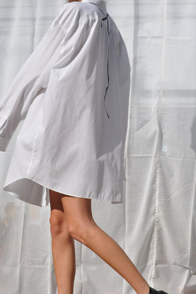BACK IMAGE OF WHITE CRISP OVERSIZED BUTTON DOWN SHIRT. HAND PAINTED TIE DETAILS  IN BLACK. UPCYCLED UNISEX  WHITE SHIRT.