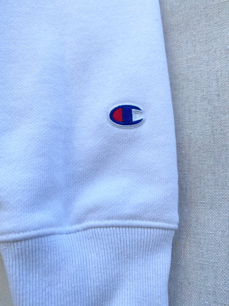 CLOSE UP IMAGE OF ORIGINAL LOGO AT  SLEEVE CUFF. REWORKED SECOND HAND COTTON CREW NECK SWEATSHIRT.