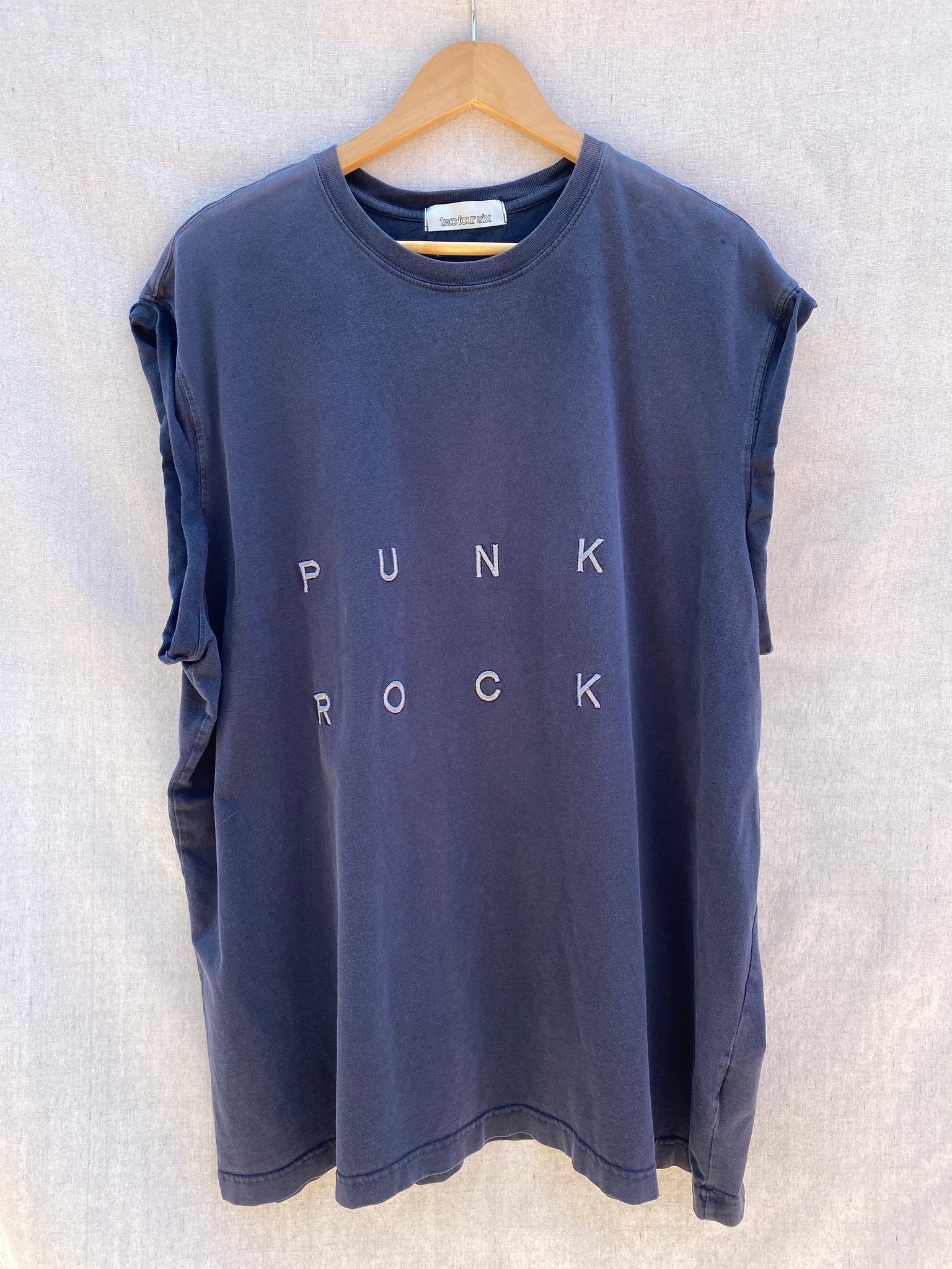 FRONT VIEW OF DARK NAVY MUSCLE TEE WITH PUNK ROCK EMBROIDERY.