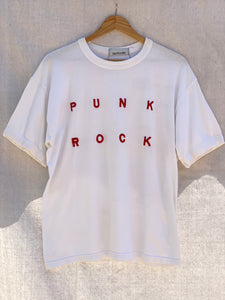FRONT VIEW OF WHITE T-SHIRT WITH RED PUNK ROCK EMBROIDERED ON IT.