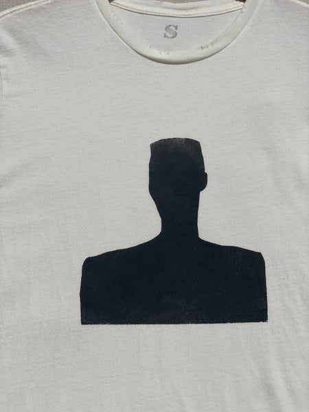 DETAILS OF SILK SCREENED MOTIF IN BLACK AND DISTRESSED NECK DETAILS.