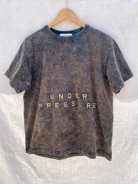 FULL FRONT VIEW OF T-SHIRT WITH UNDER PRESSURE EMBROIDERY.