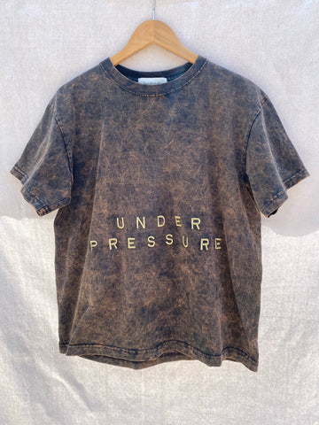 FULL FRONT VIEW OF T-SHIRT WITH UNDER PRESSURE EMBROIDERY.