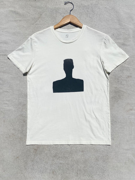 FRONT IMAGE OF DISTRESSED  CREAM T-SHIRT SILK SCREENED WITH BLACK MOTIF.
