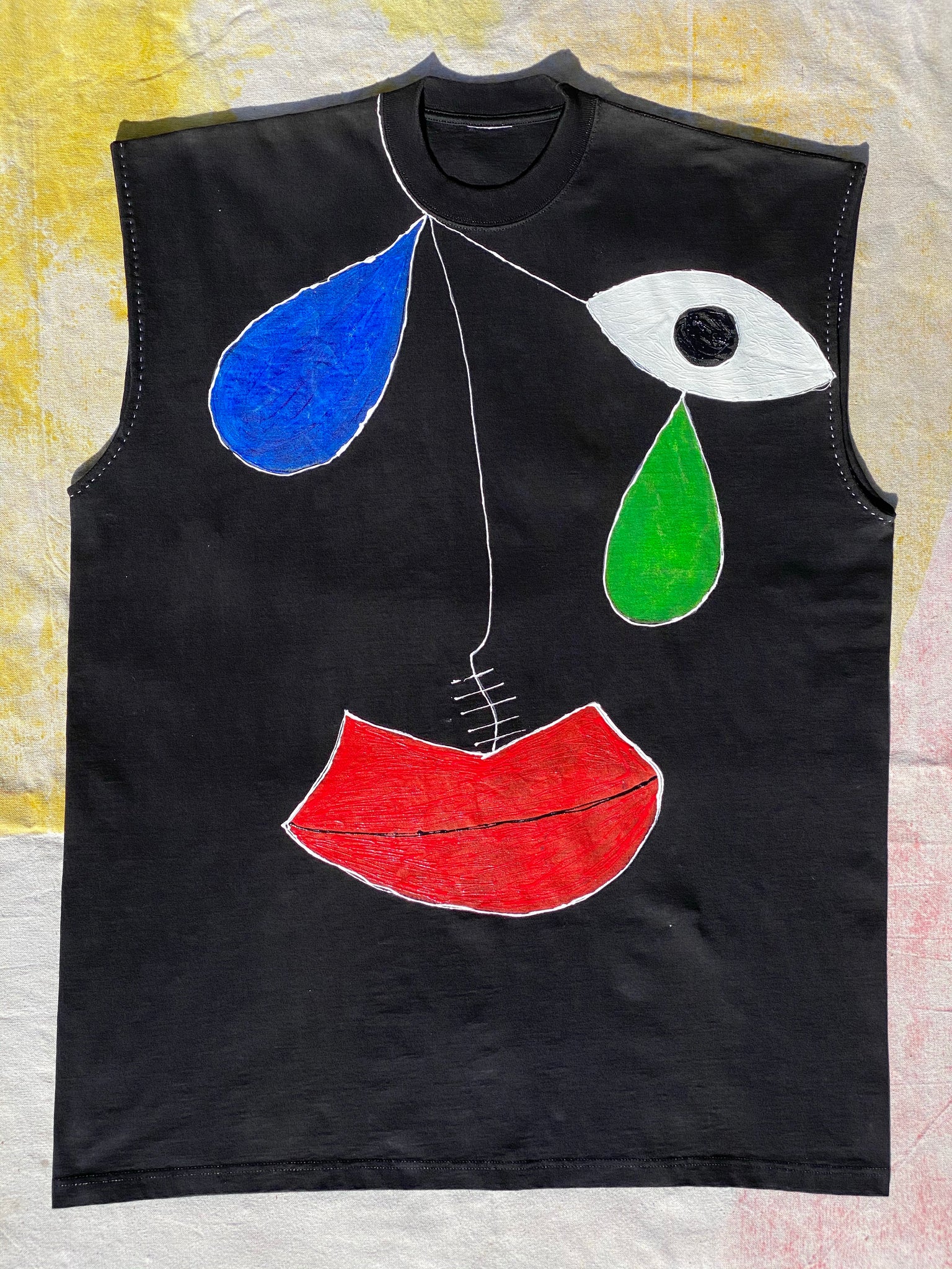 FRONT IMAGE OF HAND PAINTED SLEEVELESS BLACK TEE.