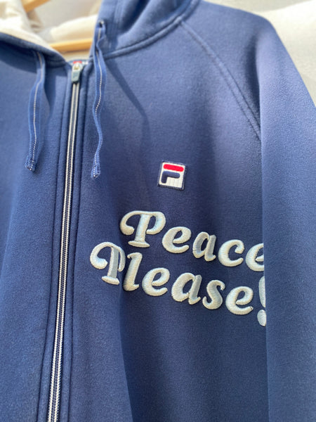 CLOSE UP IMAGE OF PEACE PLEASE! EMBROIDERY ON NAVY HOODIE.