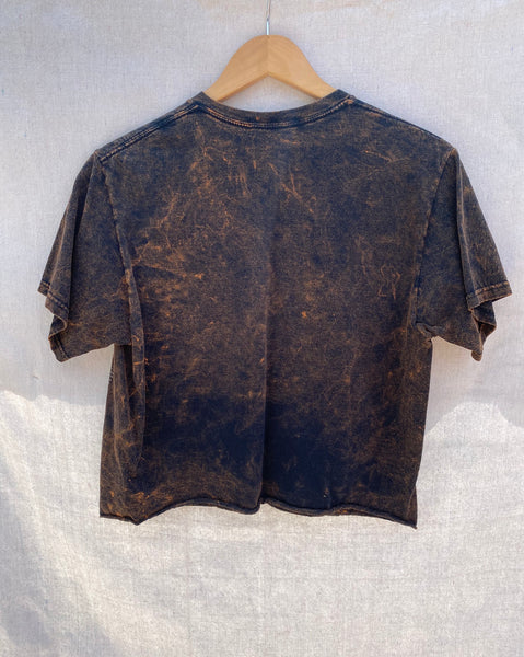 FULL VIEW OF BACK CROPPED SHIRT WITH RAW HEM AND WASHED OUT FINISH.