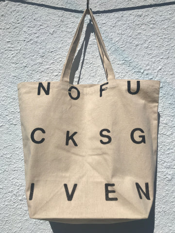 FRONT VIEW OF PRINTED TOTE BAG. PRINT READS NOFUCKSGIVEN IN BLACK.