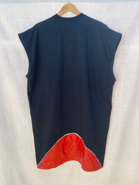 BACK IMAGE OF SLEEVELESS BLACK TEE WITH RED PAINT AT HEM.