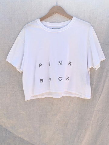 FRONT VIEW OF CROPPED WHITE TEE WITH PUNK ROCK EMBROIDERY ON IT.